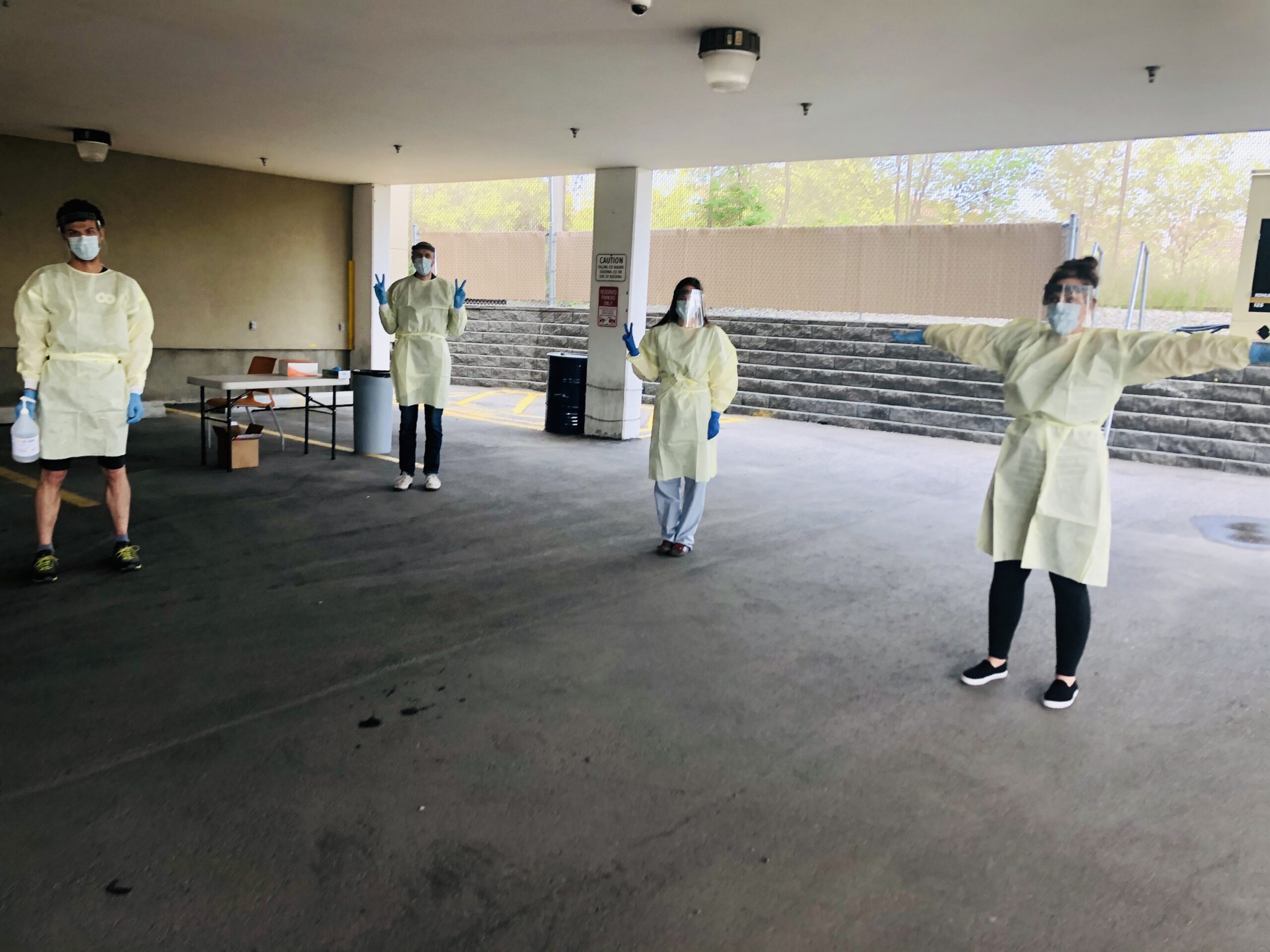 group of 4 Alex staff dressed in full PPE standing 6 feet apart